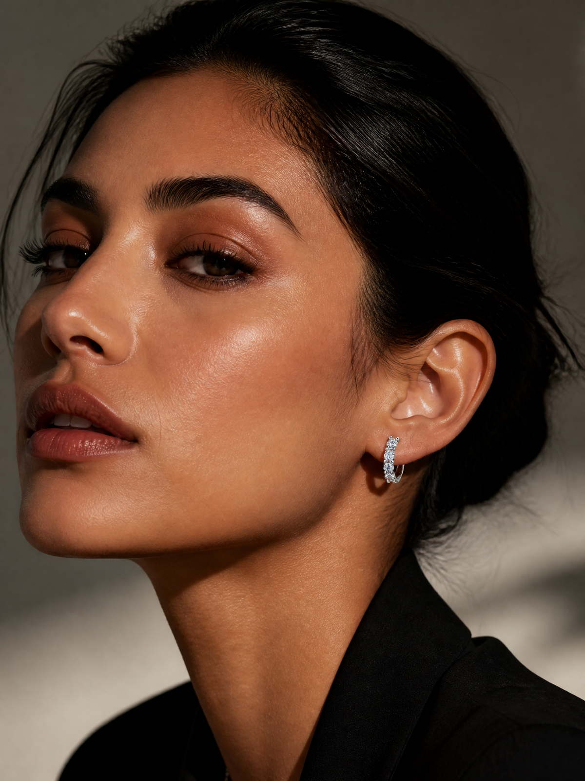 J&Y Moissanite hoop earrings showcasing sparkling round moissanite stones on silver hoops, elegant jewelry for special occasions.